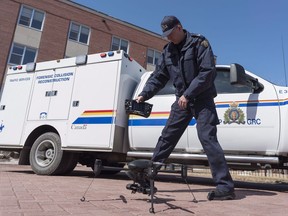 RCMP Cpl. Doug Green displays a drone, one of a number of tools used in Forensic Collision Reconstruction outside Depot Division in Regina, Saskatchewan on Thursday April 19, 2018. Newly disclosed records show the RCMP has assembled a fleet of more than 200 flying drones -- eyes in the sky that officers use for everything from accident-scene investigation to protecting VIP visitors.