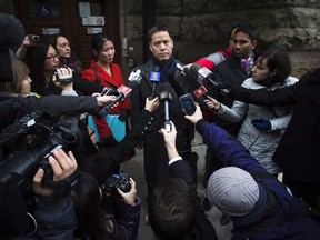 John Lee, lawyer for Qing Quentin Huang, speaks outside of the courthouse after Huang's bail hearing was put off until a later date in Toronto, Wednesday, December 4, 2013.