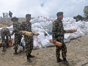 Nepali Army personnel retrieve waste oxygen bottles from the trash collected on Mount Everest on May 27, 2019, before it is transported to Kathmandu to be recycled.