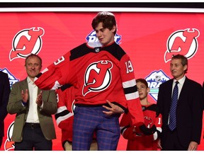 June 21, 2019; Vancouver, BC, Canada; Jack Hughes puts on a team jersey after being selected as the number one overall pick to the New Jersey Devils in the first round of the 2019 NHL Draft at Rogers Arena.