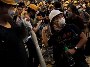 A protester throws an egg into the wall of police headquarters as people protest demanding Hong Kong’s leaders to step down and withdraw the extradition bill, in Hong Kong, China, on Friday, June 21, 2019.