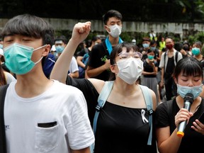 Protesters chant slogans outside the Department of Justice during a demonstration demanding that Hong Kong's leaders step down.
