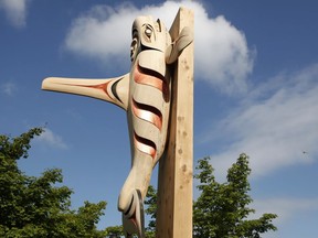 The Coast Salish orca, part of three poles which include another Welcome Figure pole and a Reconciliation Pole, is seen during a ceremony on National Peoples Indigenous Day at the Vancouver School District in Vancouver, on Friday, June 21, 2019.