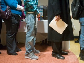 Resumes in hand, people line up at an Employment Ontario Job Fair. Despite record unemployment, job security is a big worry for Canadians.