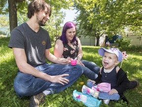 Enjoying the outdoors, at last: Kelsey, left, and Bekah Lock play with their daughter Charlie in Toronto's McCaul Park.