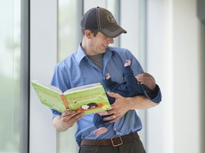 Matthew Arnold reads to his three-month-old son Owen at B.C. children's and women's hospitals on Wednesday.