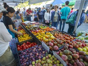 The popularity of farmers markets contributed to a record year for B.C. food sales. In this file photo, shoppers browse the Tomato Festival at the Trout Lake Farmers Market at John Hendry Park on Saturday, August 26, 2017.