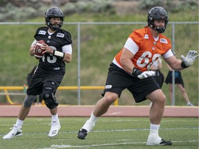 Quarterback Mike Reilly drops back to make a pass behind offensive lineman David Foucault during B.C. Lions training camp at Hillside Stadium in Kamloops.