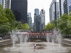 A youngster runs through the water park at Harbour Green Park in downtown Vancouver.