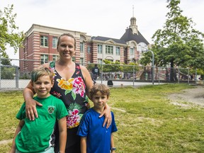 Parent Advisory Council president Arieanna Schweber with her sons Aiden, 10, and Damien, 7, at Ridgeway Elementary in North Vancouver, which is over-capacity and has 12 portable classrooms. A nearby school was sold in 2015 by the province.