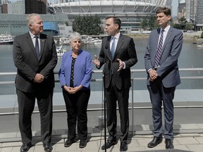 Bill Blair, minister responsible for money laundering, B.C. Finance Minister Carole James, Finance Minister Bill Morneau and B.C. Attorney General David Eby  speak to media after coming out of a meeting with provincial reps discussing the money laundering file in Vancouver,  June 13, 2019.
