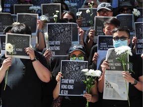 Demonstrators staged a silent stand-in downtown Vancouver Sunday to continue protesting a Chinese extradition bill in Hong Kong.