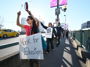 The last time B.C.'s teachers were locked in a labour dispute with their employers, they walked picket lines and staged protests. Here teachers walk across the Cambie Street Bridge in 2014, pounding pots and pans to draw attention to their binding arbitration.