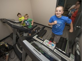 From the left, John Kabaroff, Jimmy Kabaroff and Trystan Andrews work out on a treadmill at Abbotsford Christian Elementary School.