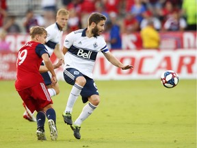 Vancouver Whitecaps midfielder Jon Erice, right, controls the ball as FC Dallas midfielder Paxton Pomykal looks to pounce during Wednesday's Major League Soccer action at Toyota Stadium in the Dallas suburb of Frisco, Texas.