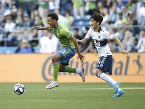 Seattle Sounders midfielder Henry Wingo (23) drives the ball against Vancouver Whitecaps midfielder Inbeom Hwang (4) during the first half at CenturyLink Field.