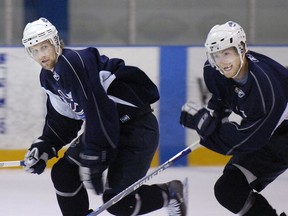 Canucks linemates Markus Naslund and Brendan Morrison gut it out during a hard practice skate at Burnaby 8 Rinks in 2006.