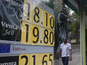 A stock monitor shows exchange rates on a storefront in Mexico City, Mexico, Friday, May 31, 2019, a day after U.S. President Donald Trump's threat to impose a 5% tariff -- that could increase incrementally to 25% -- on all Mexican imports. The economic impact for Mexico was swift. The peso dropped more than 3% against the U.S. dollar by Friday morning.