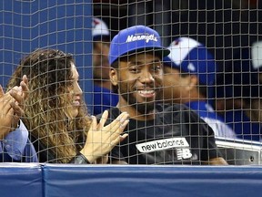 Kawhi Leonard of the Toronto Raptors watches a MLB game between the Los Angeles Angels of Anaheim and the Toronto Blue Jays at Rogers Centre on June 20, 2019 in Toronto, Canada. (Photo by Vaughn Ridley/Getty Images)