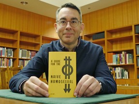 A Queer Century: Gregory Mackie, co-curator of the exhibit and an associate professor with UBC's department of English language and literatures displays A Guide for the Naive Homosexual – a 1971 pamphlet authored by Vancouverite Roedy Green, which invites interested Vancouver visitors to come over to the author's address for a cup of tea and a chat. Photo: Wan Yee Lok/UBC Media Relations