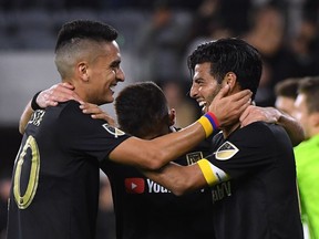 Carlos Vela of Los Angeles FC celebrates his goal, to take a 2-0 lead over FC Cincinnati, with Eduard Atuesta and Diego Rossi during a 2-0 win at Banc of California Stadium in April in Los Angeles.