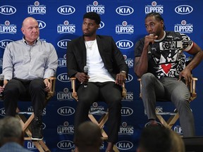 Kawhi Leonard speaks during his introductory news conference with Paul George while owner Steve Ballmer looks on (L) at Green Meadows Recreation Center on July 24, 2019 in Los Angeles, California.