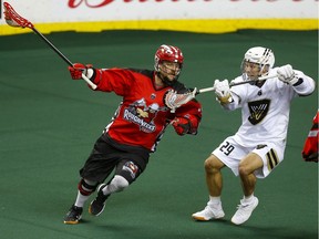 Calgary Roughnecks Dane Dobbie, left and Vancouver Warriors Colton Porter fight for the ball during their game at the Scotiabank Saddledome in Calgary, on Saturday December 15, 2018. Leah Hennel/Postmedia