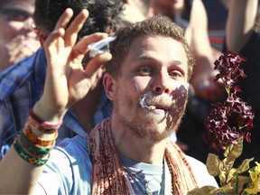 A man smokes marijuana as thousands of people gathered at 4/20 celebrations on April 20, 2016 at Sunset Beach in Vancouver, Canada.