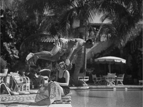 23 January, 1937. Actor Douglas Fairbanks Sr. dives over wife Sylvia Ashley into a pool in Palm Beach where they are vacationing.