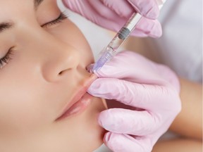 The College of Physicians and Surgeons of B.C. issued a notice Wednesday about Maria Ezzati, who was found in contempt of a court order to stop advertising herself as a doctor. This stock photo shows a lip injection being done.