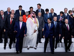 Turkey's President Recep Tayyip Erdogan (front 2nd L), US President Donald Trump (centre L), Saudi Arabia's Crown Prince Mohammed bin Salman (C), Japan's Prime Minister Shinzo Abe (centre R) and Russia's President Vladimir Putin (R) and other leaders leave after a group photo of members during the G20 Summit at the INTEX Osaka in Osaka on June 28, 2019.