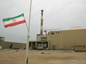 A file photo taken in April 2007 shows an Iranian flag fluttering outside the building housing the reactor of the Bushehr nuclear power plant in the Iranian port town of Bushehr, 1,200 kilometres south of Tehran. Attention is once again focused on how close Iran could be to a nuclear weapon, after Tehran said on July 7 it had started enriching uranium to a higher level than agreed in a 2015 nuclear deal abandoned by the US. Iranian officials have hinted they may go up to five percent, the level needed to produce fuel for Iran's only nuclear power station at Bushehr.