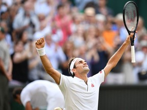 Roger Federer of Switzerland celebrates beating Rafael Nadal of Spain during their men's singles semifinal match on Friday at the 2019 Wimbledon Championships in southwest London.