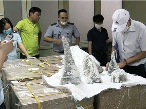 This picture from the Vietnam News Agency taken on July 25 shows customs officials at Noi Bai International Airport removing smuggled rhino horn pieces from packaging in Hanoi. Fifty-five pieces of rhino horn were found encased in plaster casts at an airport in the Vietnamese capital, authorities said on July 28, as the country tries to crack down on sophisticated wildlife smuggling routes.