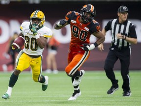 Edmonton Eskimos #30 Martese Jackson is chased by BC Lions #90 Meffy Koloamatangi in a regular season CFL football game at BC Place, Vancouver, July 11 2019.