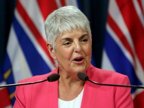 B.C. Finance Minister Carole James releases the provincial public accounts report during a press conference at the B.C. Legislature in Victoria on Thursday. James said B.C. posted a $1.5 billion operating surplus in the 2018-19 report.