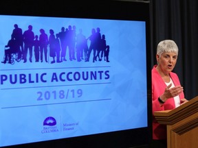 B.C. Finance Minister Carole James releases the provincial public accounts report during a press conference at the B.C. Legislature in Victoria on Thursday. James said B.C. posted a $1.5 billion operating surplus in the 2018-19 report.