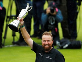 Ireland's Shane Lowry celebrates with the Claret Jug trophy after winning the 148th Open Championship at the  Royal Portrush Golf Club in Northern Ireland.