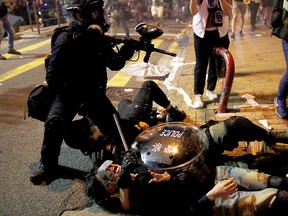 Police officers detain a demonstrator during a protest against police violence during previous marches, near China's Liaison Office, Hong Kong, China July 28, 2019.