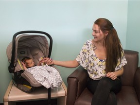 Mckenna Smith, 22, with her son Taysen in the A Way Home Kamloops offices. McKenna was homeless for eight months in Penticton. Photo: Gerry Kahrmann/Postmedia