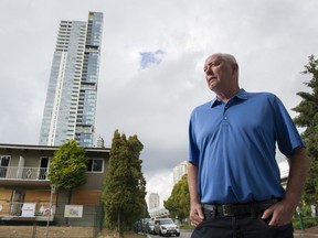 Then-Burnaby mayoral candidate Mike Hurley outside low-rise apartment buildings vacated for development on Sept. 13, 2018.