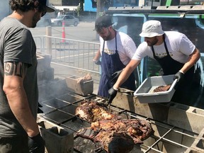 David Bowkett, Rhys Amber and Christopher Scott (left to right) work on a whole barbecued hog at Big Day Barbecue pop-up.