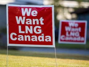 Signs reading "We Want LNG Canada" stand on a lawn in the residential area of Kitimat, British Columbia.