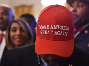 A man wearing a "Make American Great Again" (MAGA) cap awaits the start of a White House reception in honor of National African American History Month hosted by US President Donald Trump and first lady Melania on February 21, 2019 in Washington, DC.