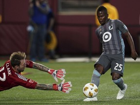Minnesota United forward Carlos Darwin Quintero, who the Vancouver Whitecaps will have to keep an eye on Saturday, attempts to score on Portland Timbers goalkeeper Steve Clark during a MLS match in Minneapolis.