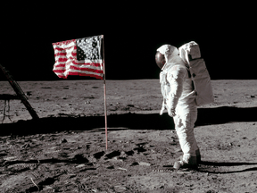 Astronaut Buzz Aldrin, lunar module pilot for Apollo 11, beside the deployed United States flag during an extravehicular activity on the moon, July 20, 1969.