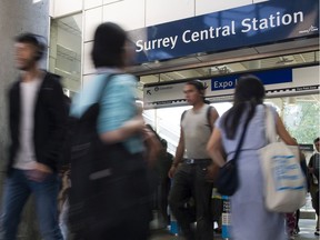 Transit riders at the Surrey Central SkyTrain station.