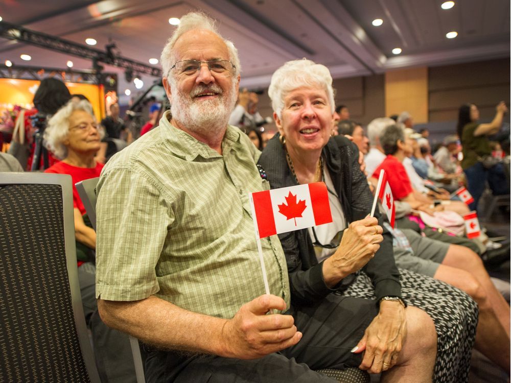 People take part in a Canada Day citizenship ceremony before the