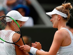 U.S. player Alison Riske (R) shakes hands with Australia's Ashleigh Barty (L) after Riske won their women's singles fourth round match on the seventh day of the 2019 Wimbledon Championships at The All England Lawn Tennis Club in Wimbledon, southwest London, on July 8, 2019.