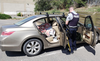 Kamloops Mounties clean out Don Levasseur’s car of suspected stolen material after the vehicle was found parked behind Sahali Mall.